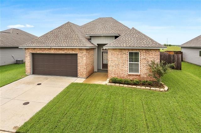 324 Ashton Oaks Ln, Luling, LA 70070 - ranch-style house with a garage, driveway, and brick siding