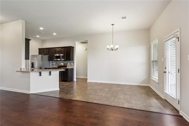 324 Ashton Oaks Ln, Luling, LA 70070 - kitchen featuring appliances with stainless steel finishes, a chandelier, a breakfast bar, recessed lighting, and a peninsula