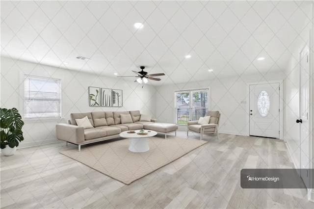 living room featuring light tile patterned floors, ceiling fan, and visible vents