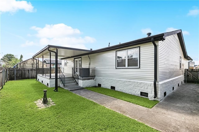 view of front of home with covered porch, crawl space, a fenced backyard, and a front lawn
