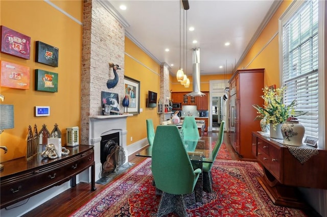 1907 N Rampart St, New Orleans, LA 70116 - dining space featuring dark wood finished floors, crown molding, a wealth of natural light, and a fireplace with flush hearth