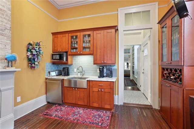 1907 N Rampart St, New Orleans, LA 70116 - kitchen with dark wood finished floors, backsplash, appliances with stainless steel finishes, and a sink