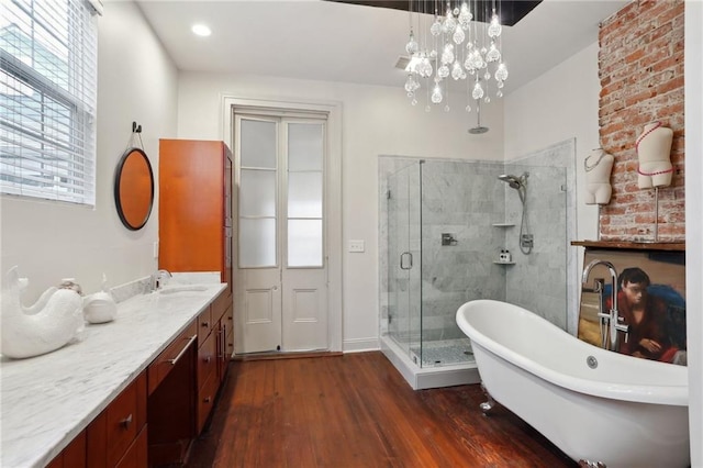 1907 N Rampart St, New Orleans, LA 70116 - full bath with vanity, a freestanding bath, a shower stall, and wood finished floors