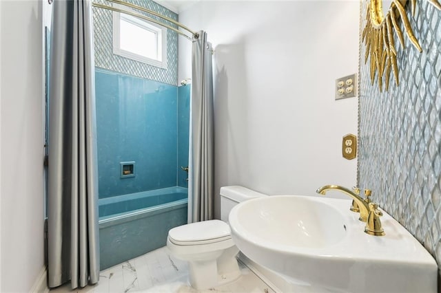 bathroom with toilet, washtub / shower combination, and marble finish floor