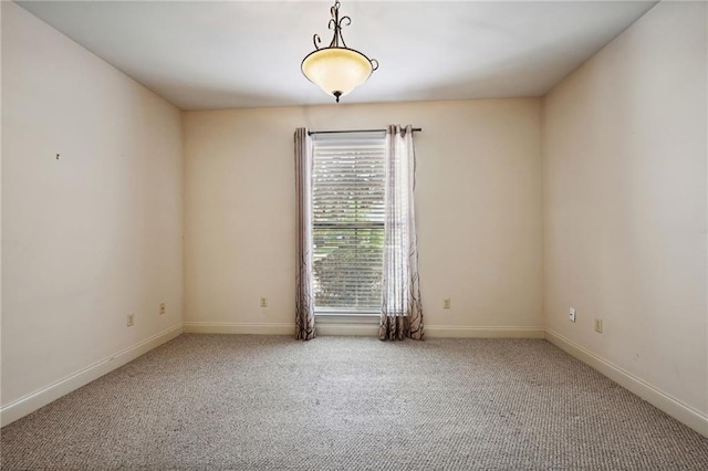 carpeted spare room with baseboards