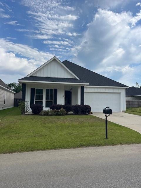 view of front facade featuring concrete driveway, board and batten siding, a front lawn, and a garage