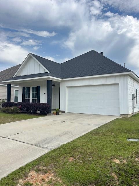 4057 Monarch Ln, Covington, LA 70433 - single story home with a shingled roof, an attached garage, a front lawn, board and batten siding, and driveway