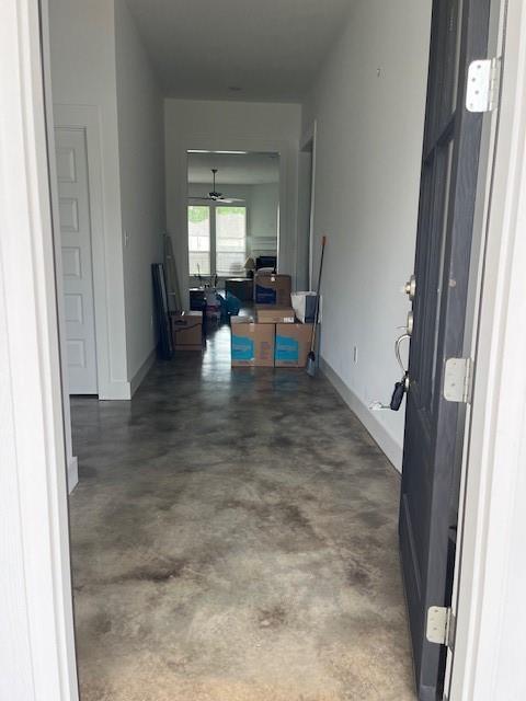 4057 Monarch Ln, Covington, LA 70433 - hallway with baseboards and concrete floors