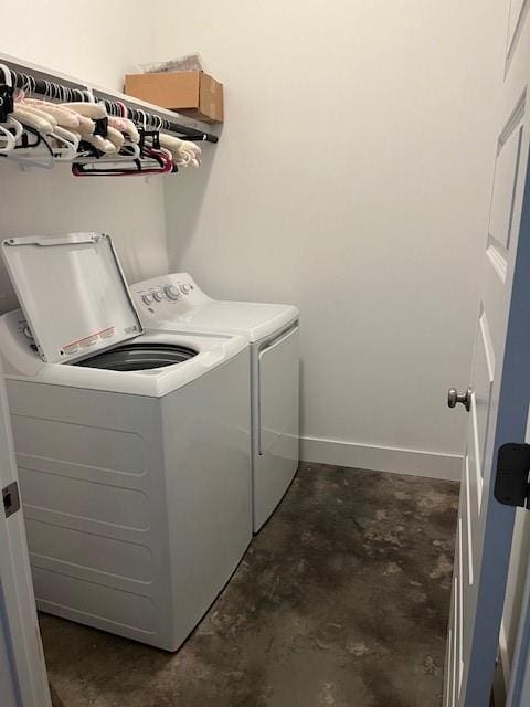 clothes washing area featuring separate washer and dryer and laundry area