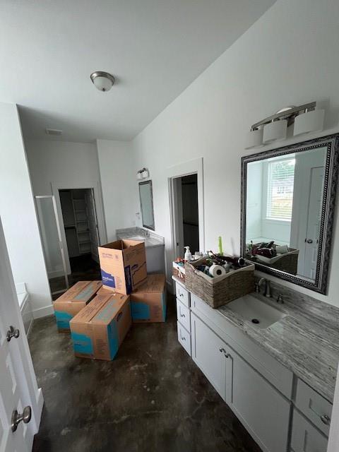 bathroom with vanity, unfinished concrete floors, and a shower stall