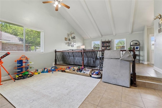 rec room with tile patterned floors, vaulted ceiling with beams, baseboards, and ceiling fan