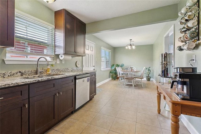 kitchen featuring light stone countertops, dark brown cabinetry, a sink, dishwasher, and light tile patterned floors