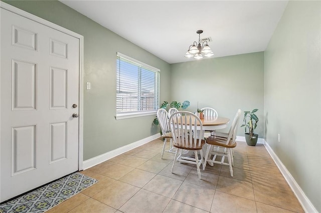 dining room featuring baseboards, a chandelier, and light tile patterned floors