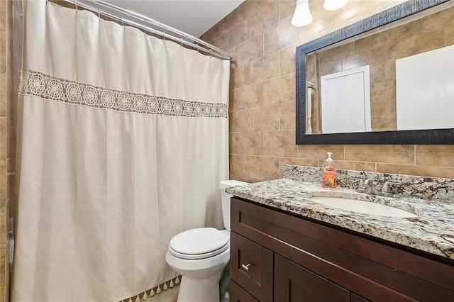 bathroom featuring tile walls, vanity, toilet, and a shower with shower curtain