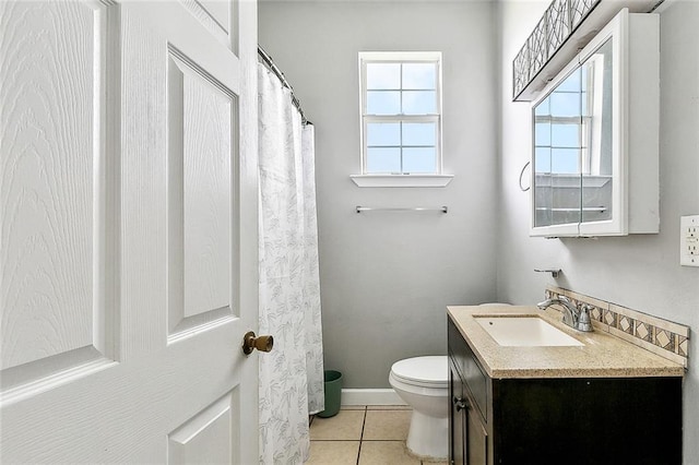 bathroom with toilet, tile patterned flooring, and vanity