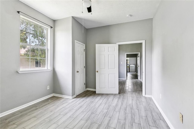 unfurnished bedroom featuring baseboards and wood finished floors