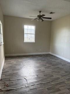 unfurnished room featuring baseboards, ceiling fan, and wood finished floors