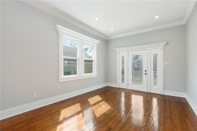 interior space featuring baseboards, ornamental molding, recessed lighting, and wood finished floors