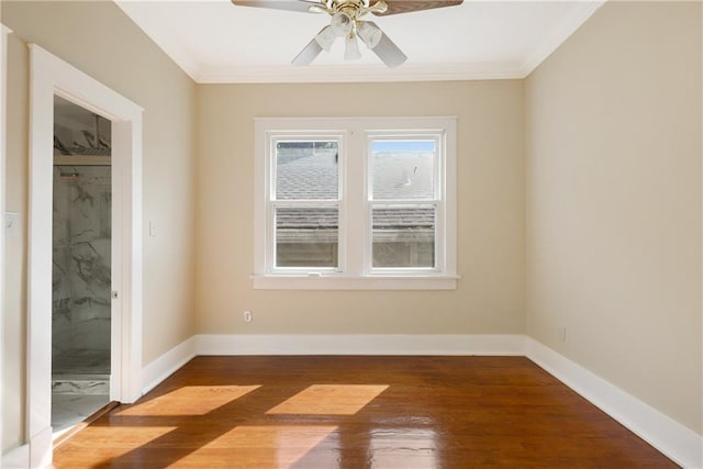unfurnished bedroom featuring crown molding, baseboards, and wood finished floors