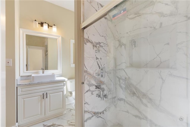 full bathroom with toilet, a marble finish shower, marble finish floor, and vanity