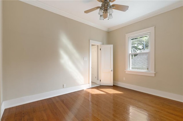 unfurnished room with ceiling fan, baseboards, ornamental molding, and wood finished floors