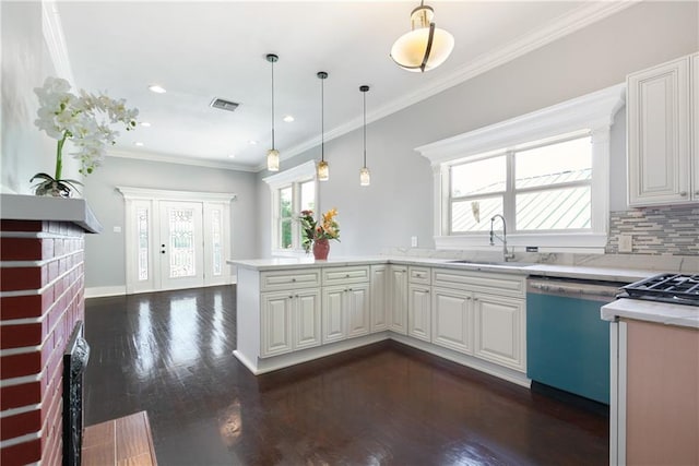 kitchen featuring a sink, a wealth of natural light, visible vents, and dishwasher