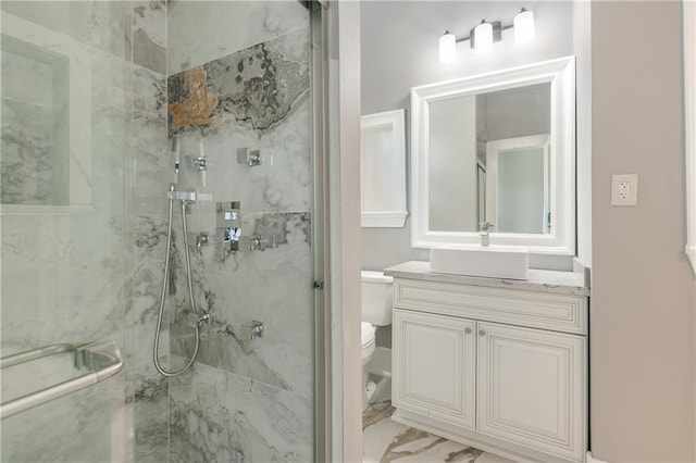 bathroom featuring vanity, marble finish floor, a marble finish shower, and toilet