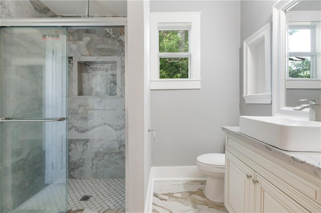 bathroom featuring vanity, toilet, a marble finish shower, and marble finish floor