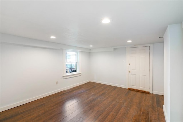 below grade area with baseboards, recessed lighting, and dark wood-style floors