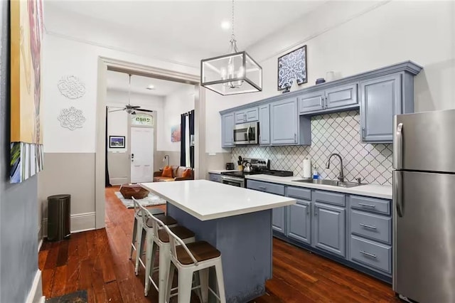 2009-11 N Claiborne Ave, New Orleans, LA 70116 - kitchen featuring a sink, a kitchen island, gray cabinetry, and stainless steel appliances