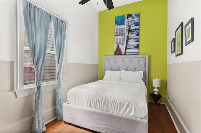 2009-11 N Claiborne Ave, New Orleans, LA 70116 - bedroom with baseboards, a ceiling fan, and wood finished floors