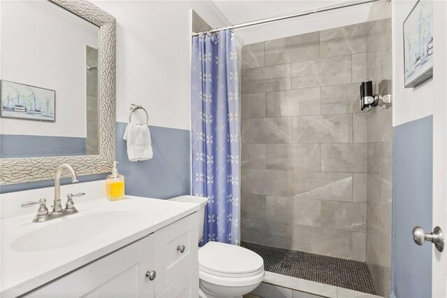 2009-11 N Claiborne Ave, New Orleans, LA 70116 - bathroom with vanity, a tile shower, and toilet