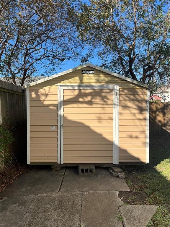 view of shed with fence