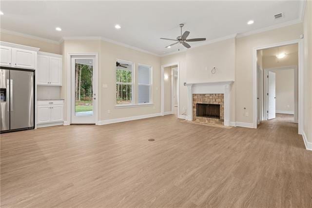 166 Egret St, Covington, LA 70433 - unfurnished living room with light wood-style floors, recessed lighting, a fireplace with flush hearth, baseboards, and a ceiling fan
