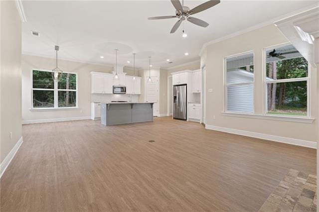 166 Egret St, Covington, LA 70433 - unfurnished living room with crown molding, light wood-style floors, baseboards, ceiling fan, and recessed lighting