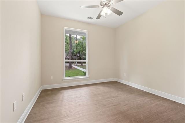 166 Egret St, Covington, LA 70433 - empty room featuring dark wood-style flooring, baseboards, and a ceiling fan