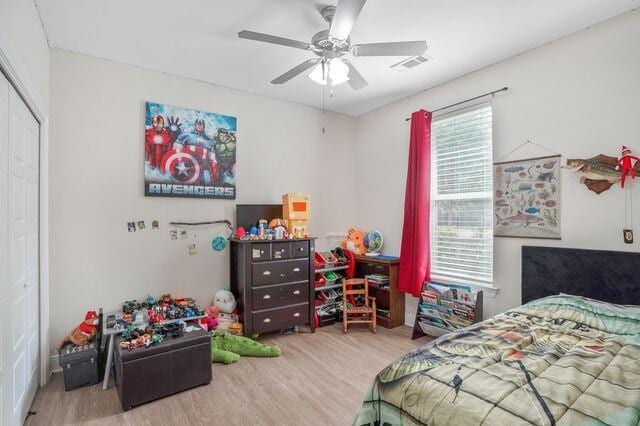 166 Egret St, Covington, LA 70433 - bedroom with wood finished floors, a closet, multiple windows, and a ceiling fan