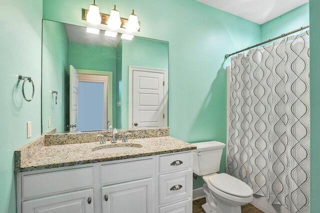 166 Egret St, Covington, LA 70433 - bathroom with toilet, vanity, and a shower with shower curtain