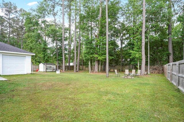view of yard featuring a fenced backyard and an outdoor structure