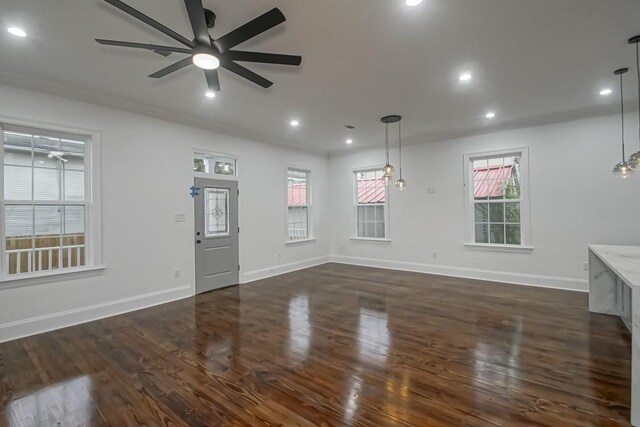 interior space with a ceiling fan, baseboards, recessed lighting, and dark wood-type flooring