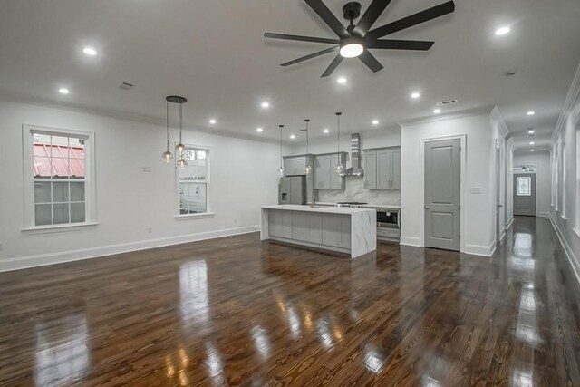 unfurnished living room featuring dark wood-style flooring, a ceiling fan, baseboards, and recessed lighting