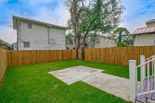 view of yard with a fenced backyard and a patio