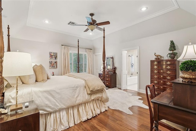 bedroom featuring ornamental molding, wood finished floors, baseboards, ensuite bathroom, and recessed lighting