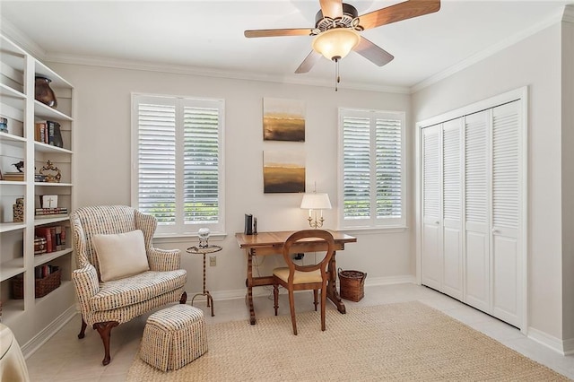 living area featuring ornamental molding, a ceiling fan, and a healthy amount of sunlight