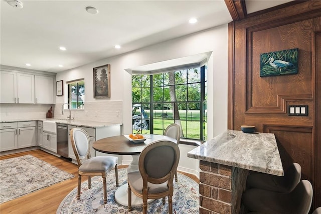 dining room with light wood finished floors and recessed lighting