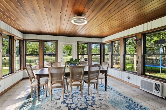 sunroom / solarium featuring wooden walls, tile patterned floors, a wall mounted AC, and wood ceiling