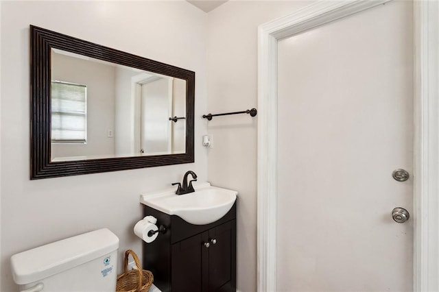 half bath with vanity and toilet