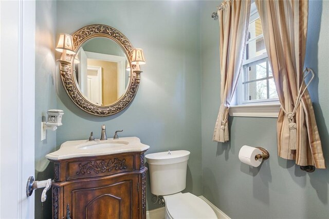half bathroom featuring toilet and vanity