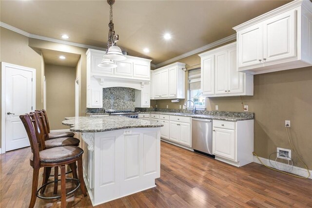 kitchen with a kitchen island, dark wood-style flooring, crown molding, stainless steel dishwasher, and white cabinets