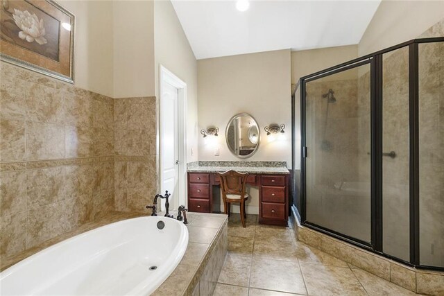 full bath featuring a garden tub, tile patterned flooring, a stall shower, and vanity